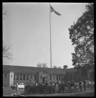 Students and teachers facing the U.S. Flag